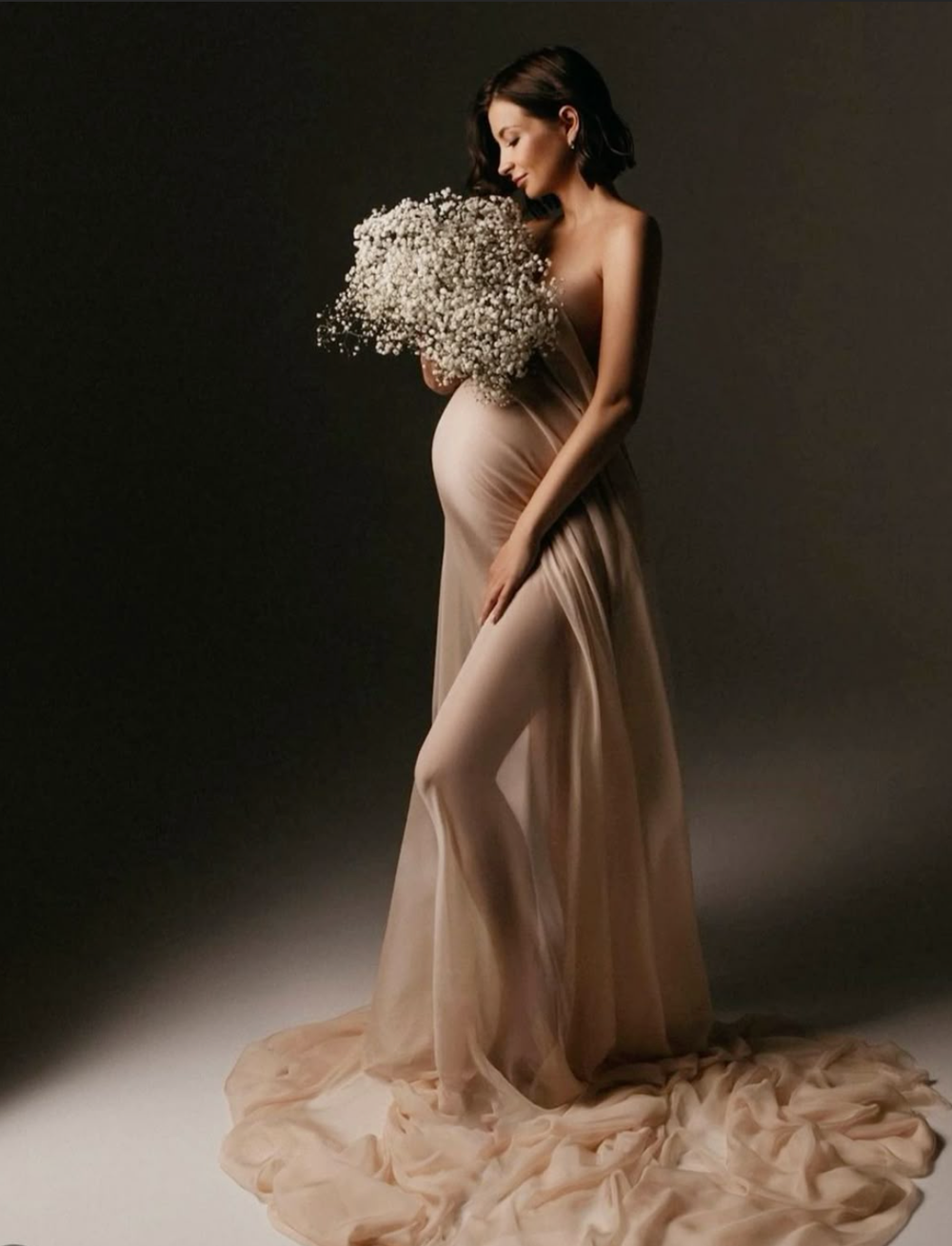 A series of maternity photos showing a woman in a flowing beige gown against a dark backdrop in various elegant poses.