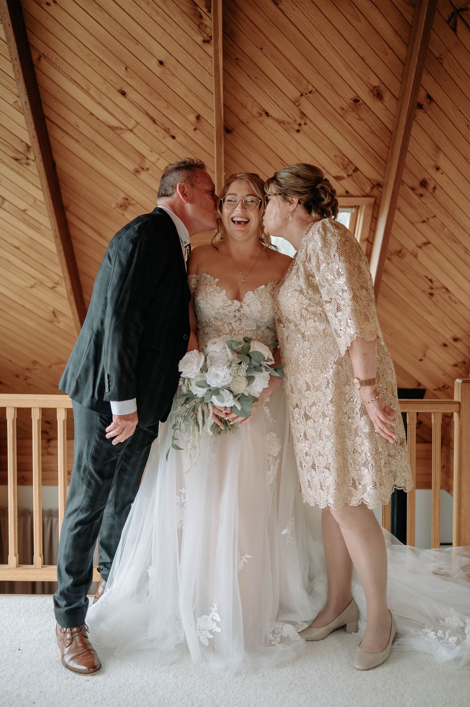 Emotional moment shared during wedding ceremony in wooden chapel interior.