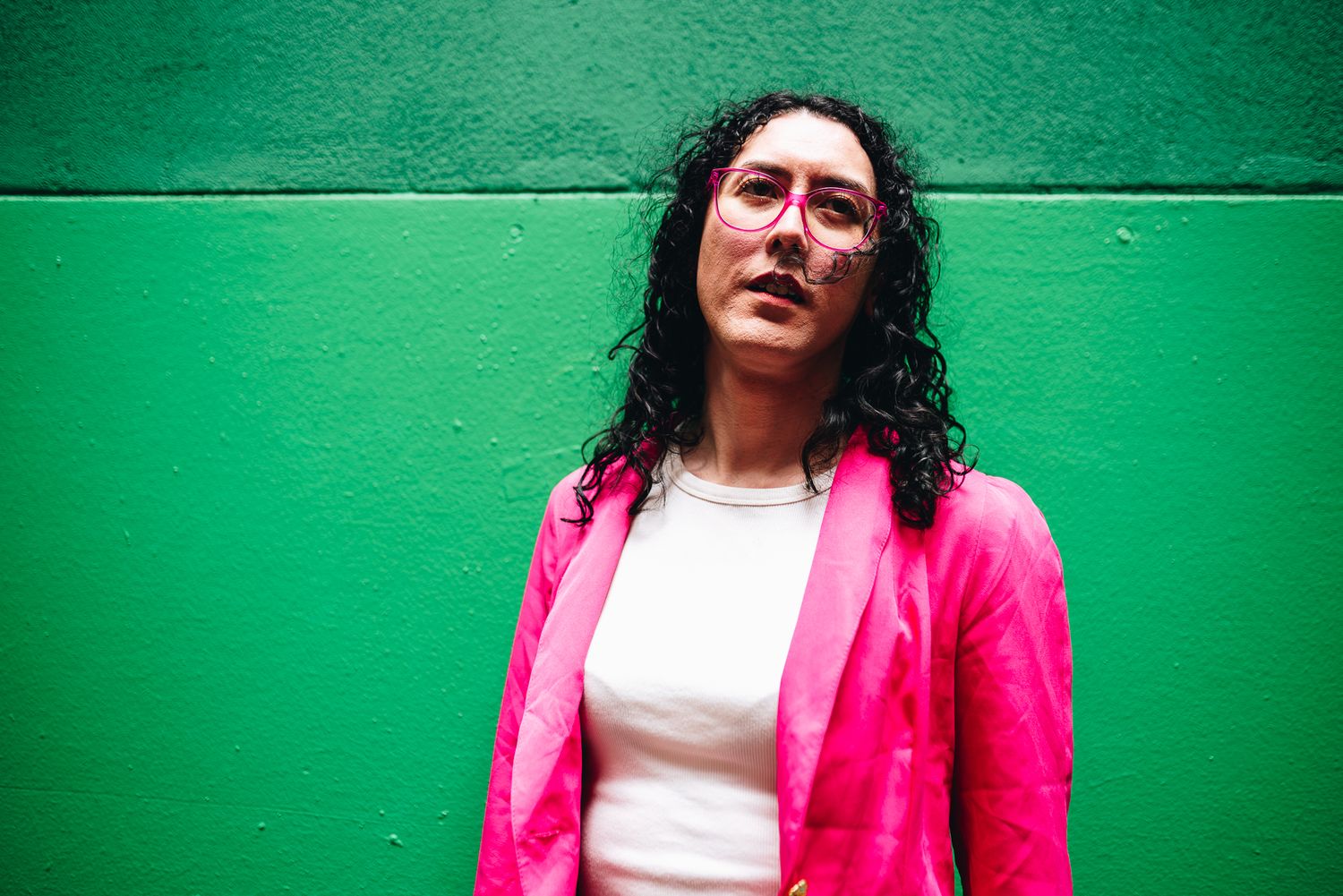 Melbourne lifestyle branding photo of person in pink puffer jacket and boots posing on urban brick-lined laneway—creative street photography