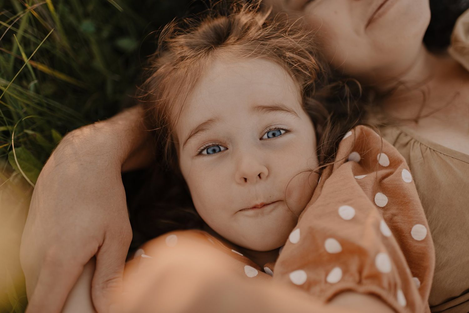 Close-up portrait in soft natural lighting among wildflowers.