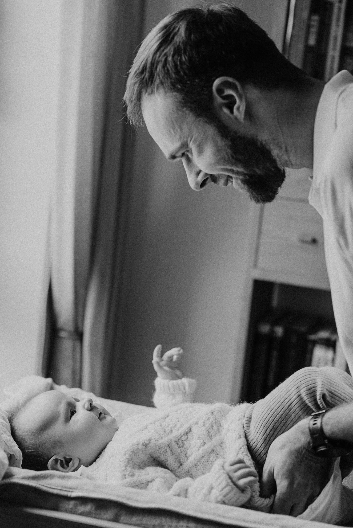 A tender moment between parent and baby during a diaper change.