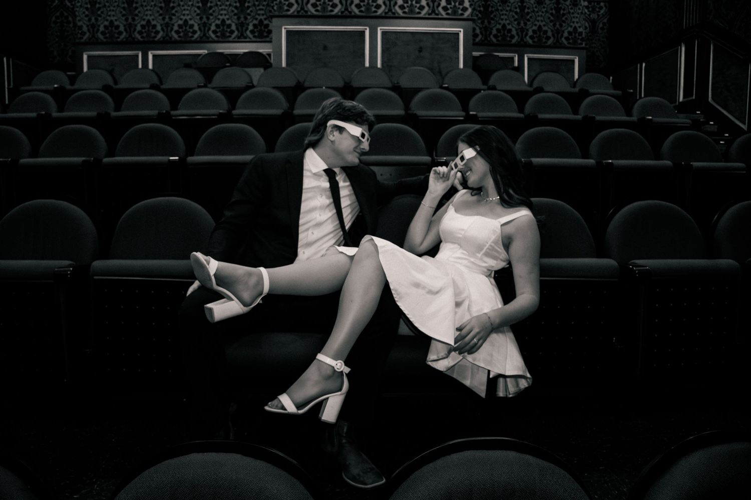 Bride and groom look at each other in a theatre in a cinematic moment in an Utah theater.