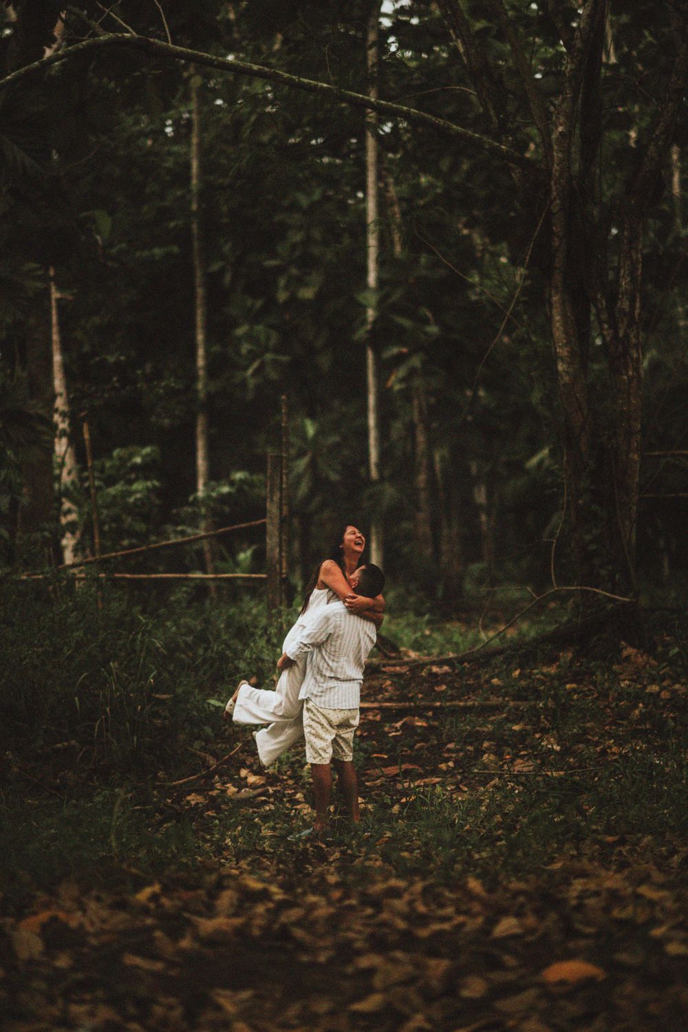 A joyful lift captured in a moody forest setting.