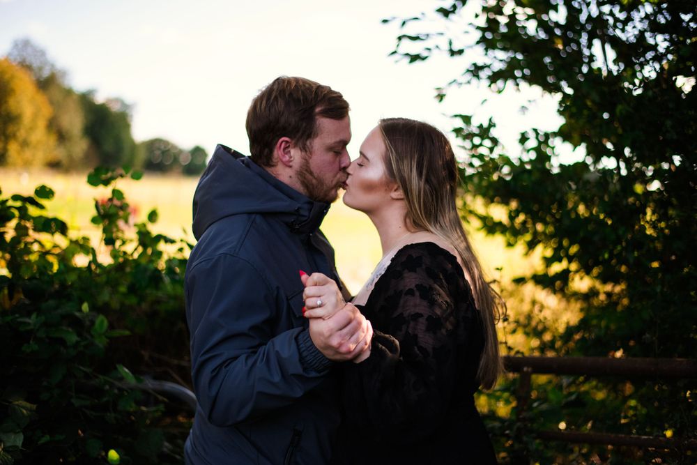A romantic sunset moment between a couple in a natural outdoor setting.