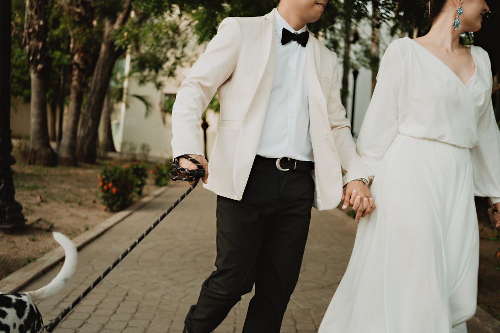 Blurred shot of couple walking and smiling, dog on the side