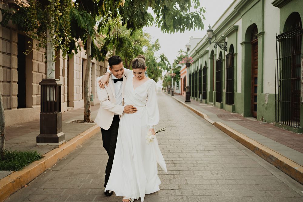Couple walking and smiling happily in historic center