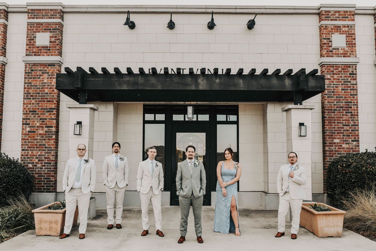 Groom and groomsmen wearing linen suits with powder blue ties at a winter wedding