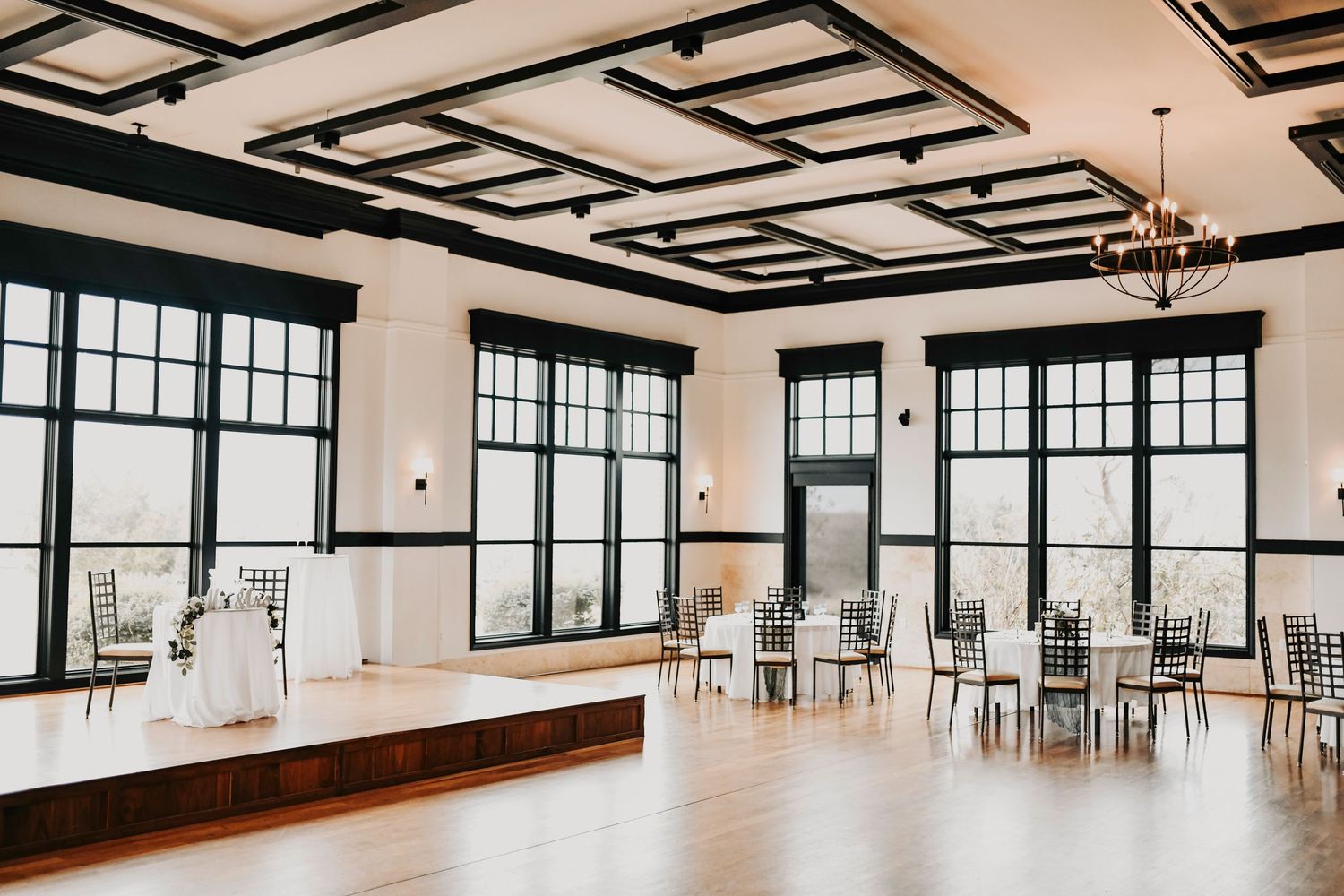 Light-filled modern wedding reception hall with elevated tablescape design and open layout