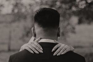 A series of black and white photos showing hands massaging someone's neck and shoulders in a therapeutic manner.