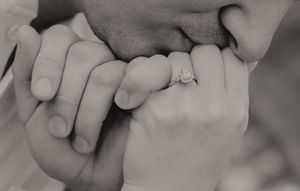 Black and white detail shots of hands tenderly touching.