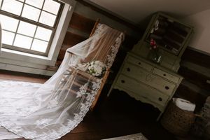 Ethereal bridal veil detail shot near window with natural light streaming in.