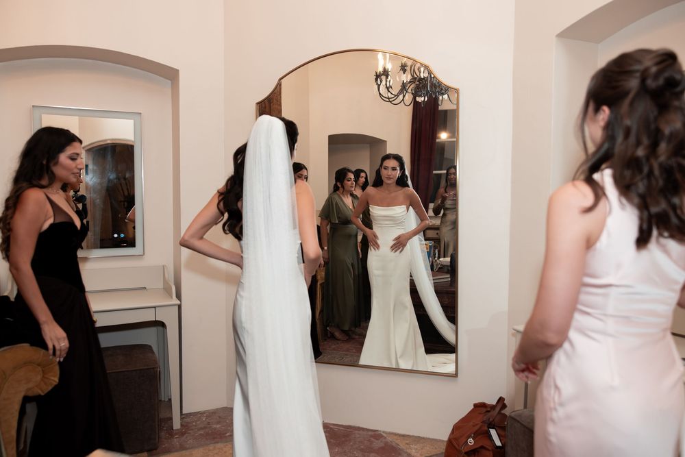 A series of bridal preparation photos showing women in wedding dresses getting ready in a dressing room with mirrors.