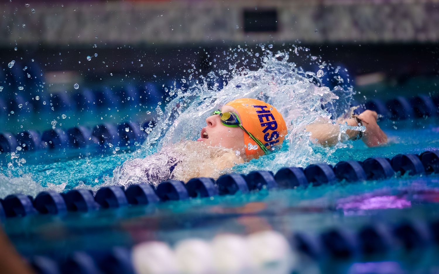 Hershey High School Trojan Swimming races in orange swim caps by SportsFox Photography, Hershey PA