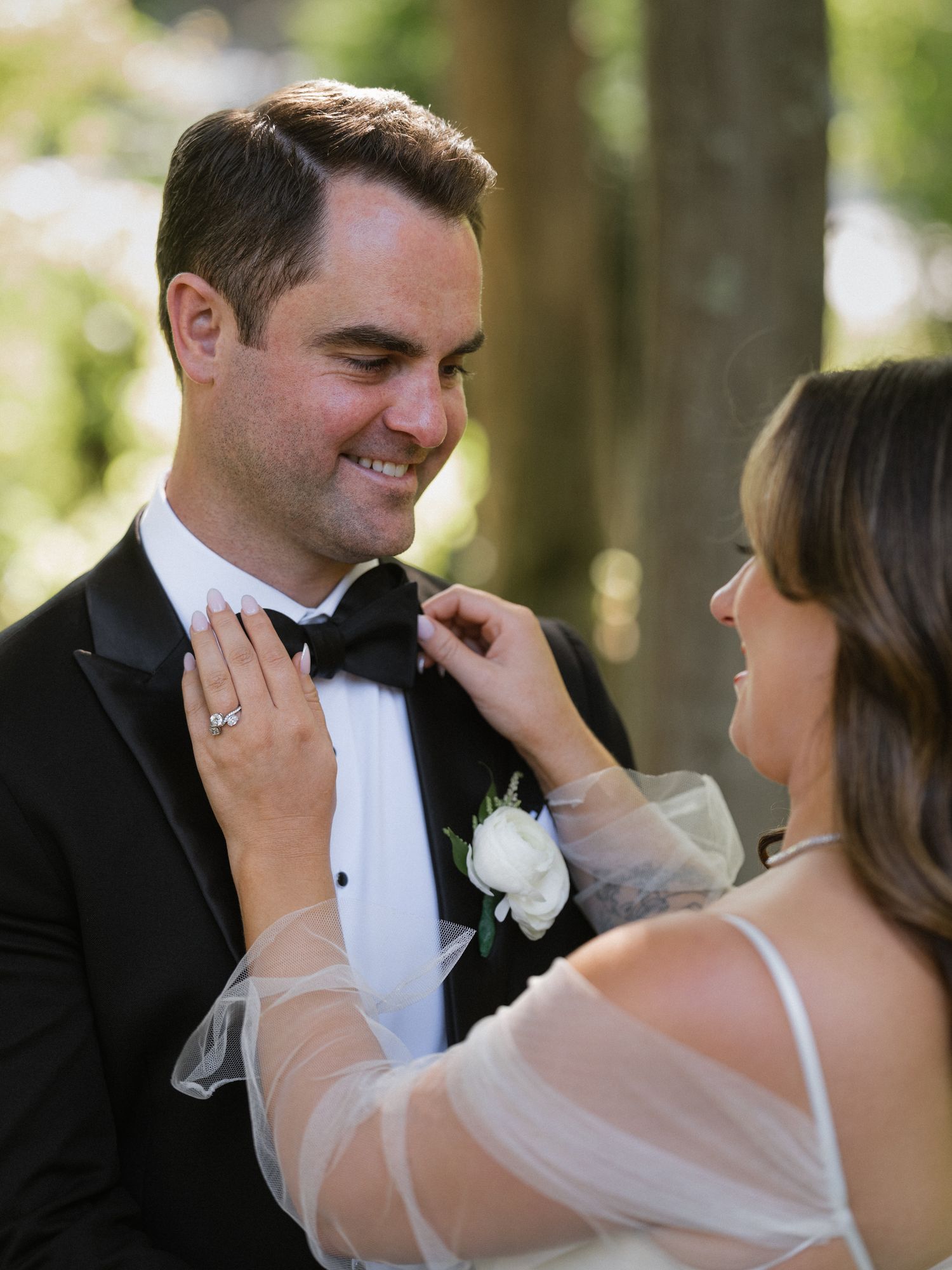 Romantic moment between newlyweds outdoors with soft natural lighting.