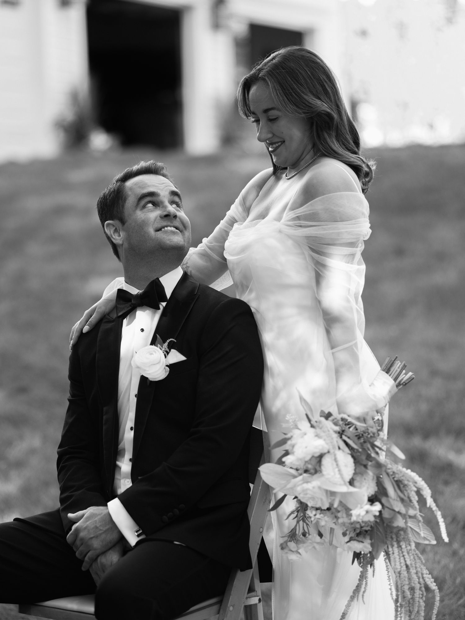 Black and white wedding portrait showing tender moments between newlyweds.
