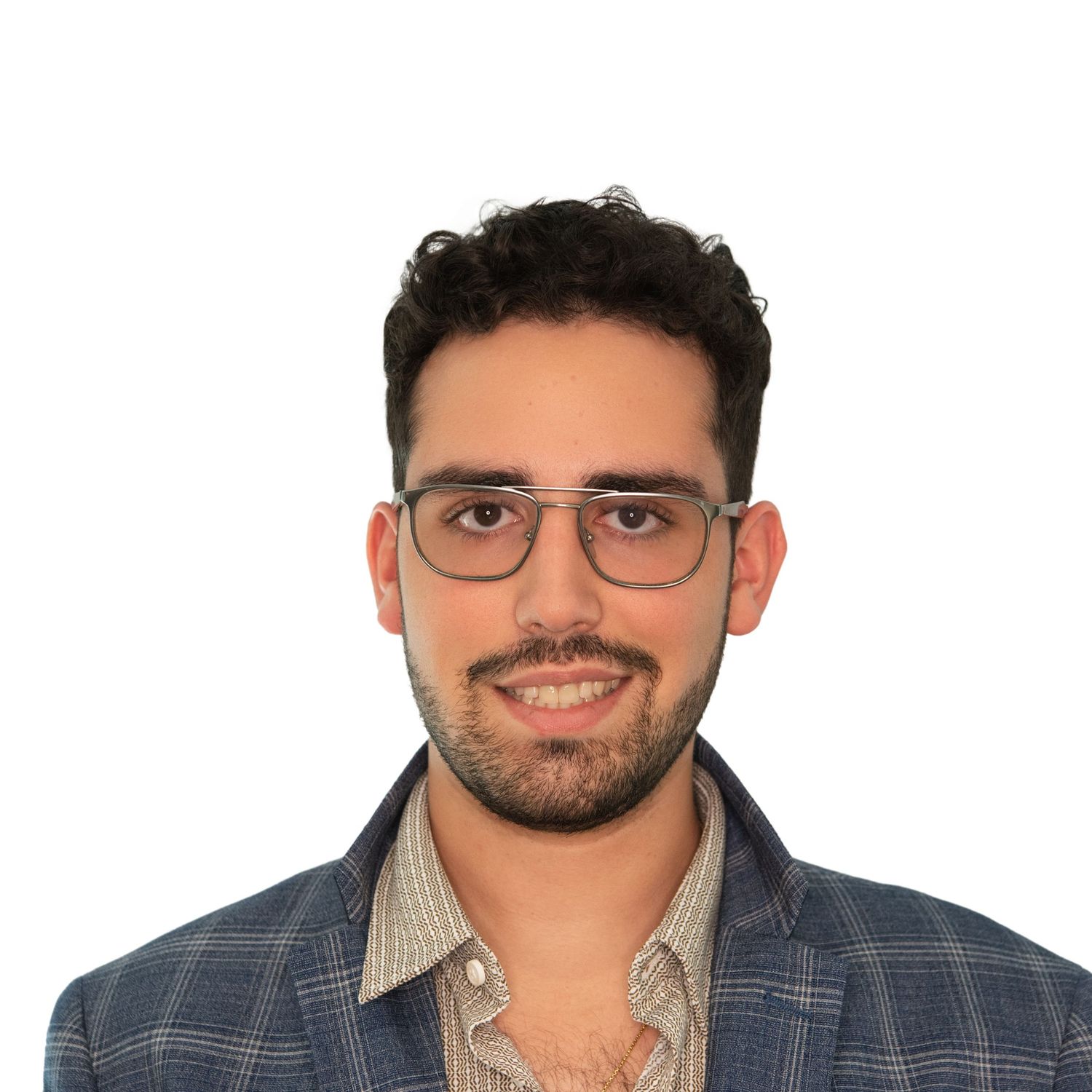 Professional headshot of a man with glasses and a plaid blazer photographed in a Boston office by Leah Ramuglia.