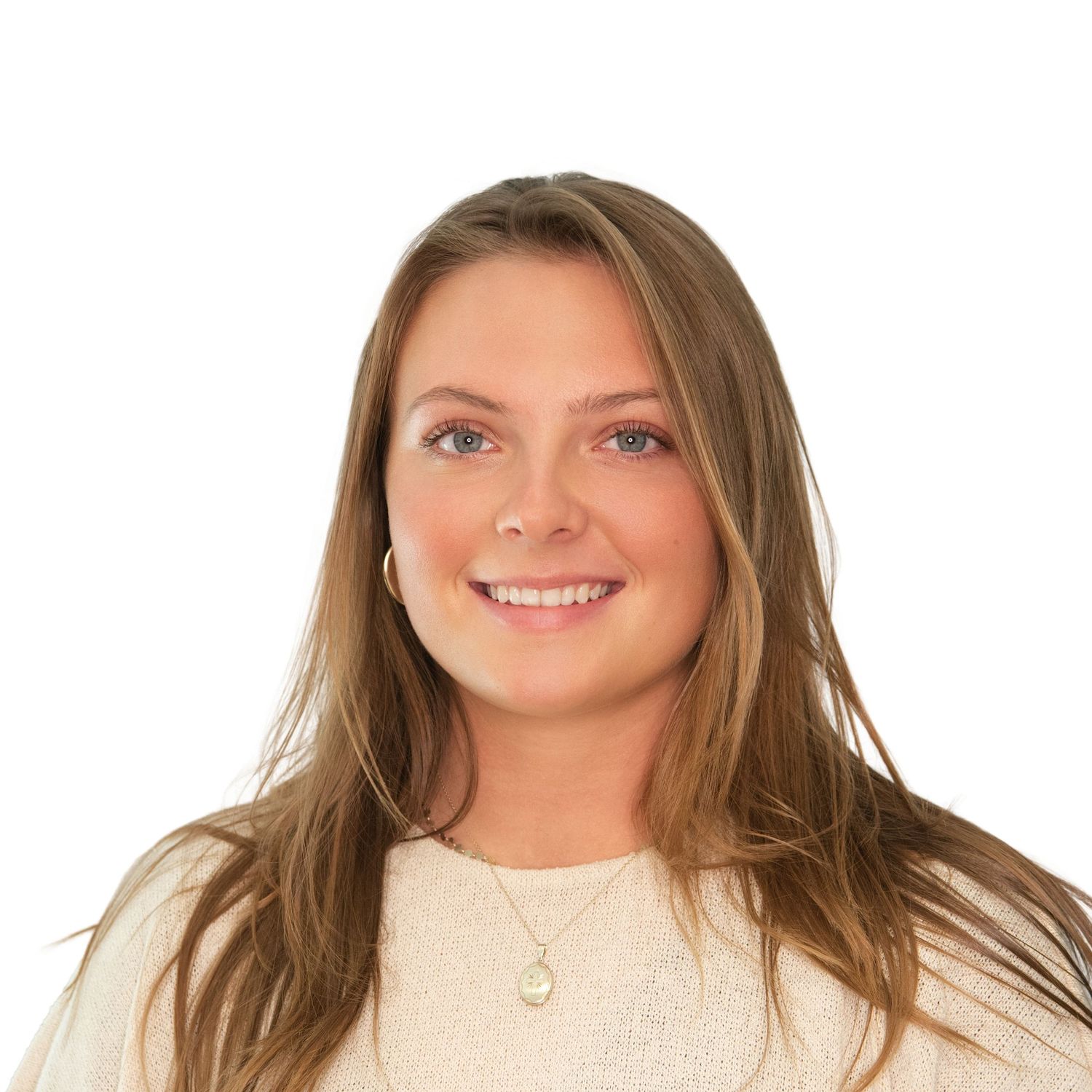 Woman with long brown hair wearing a white sweater smiling at the camera during headshots with Leah Ramuglia Photography in Boston, MA.