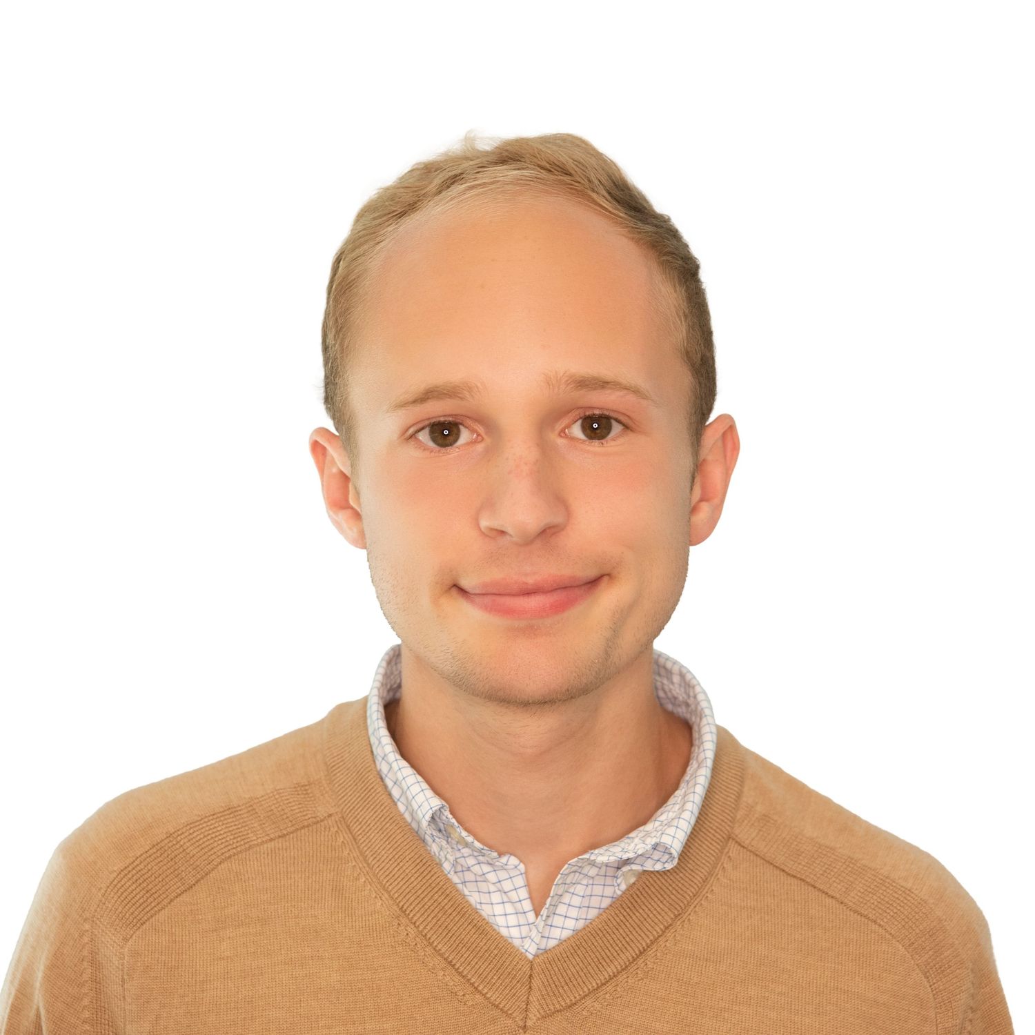 Professional headshot of someone in a tan sweater over a white collared shirt against a white background. Leah Ramuglia Photography.