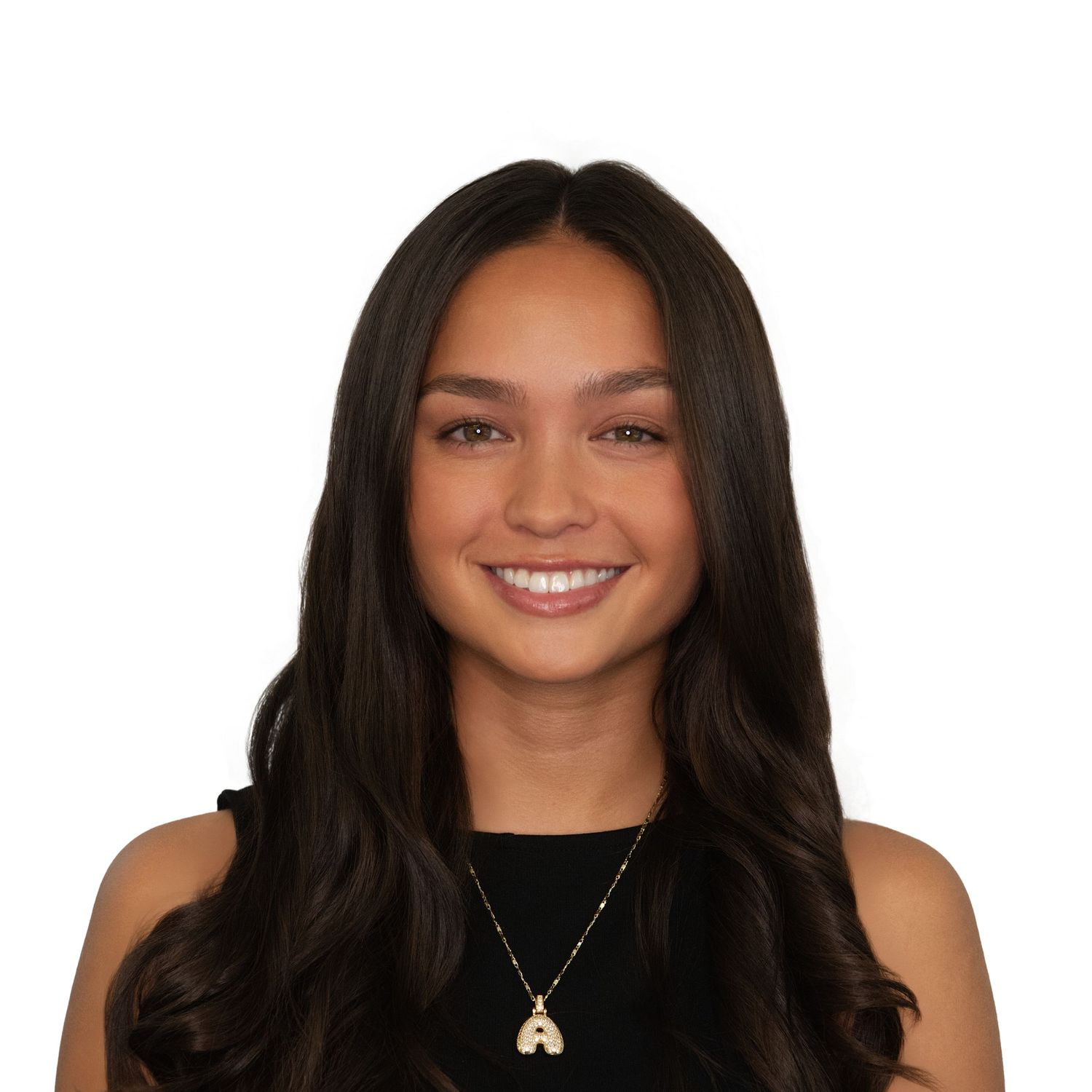 A smiling woman with long dark hair wearing a black sleeveless top and gold necklace in professional headshots by Leah Ramuglia Photography.