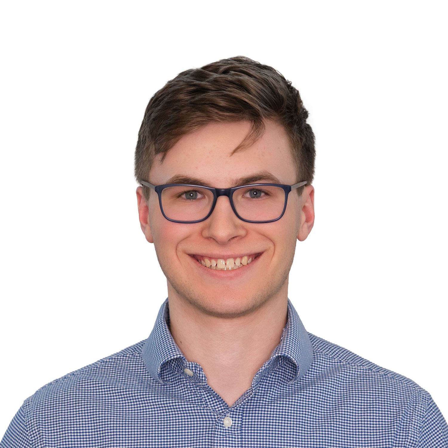 Professional headshot of a young man in glasses and a blue checkered button-down shirt, photographed by Leah Ramuglia in Boston, MA.