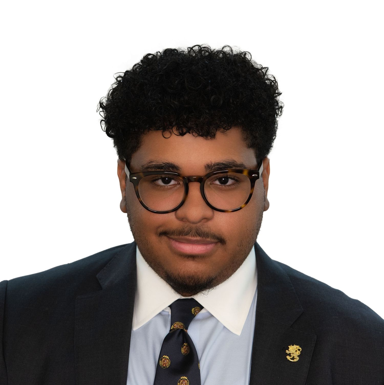 Men’s Professional headshots with Leah Ramuglia Photography of men with glasses and a dark suit & a tie against a light background.