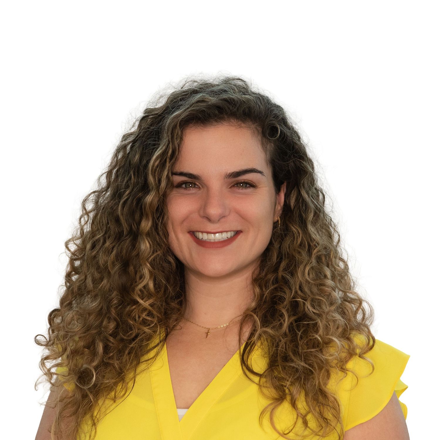 Woman with curly brown hair wearing a yellow top in a professional headshot by Leah Ramuglia Photography in Boston, MA.