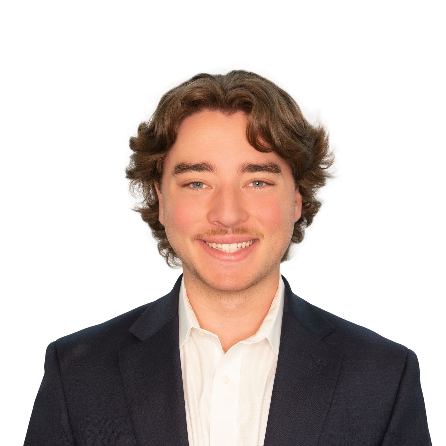 Young person in black suit and white shirt smiling for Professional headshots in Boston with Leah Ramuglia Photography.
