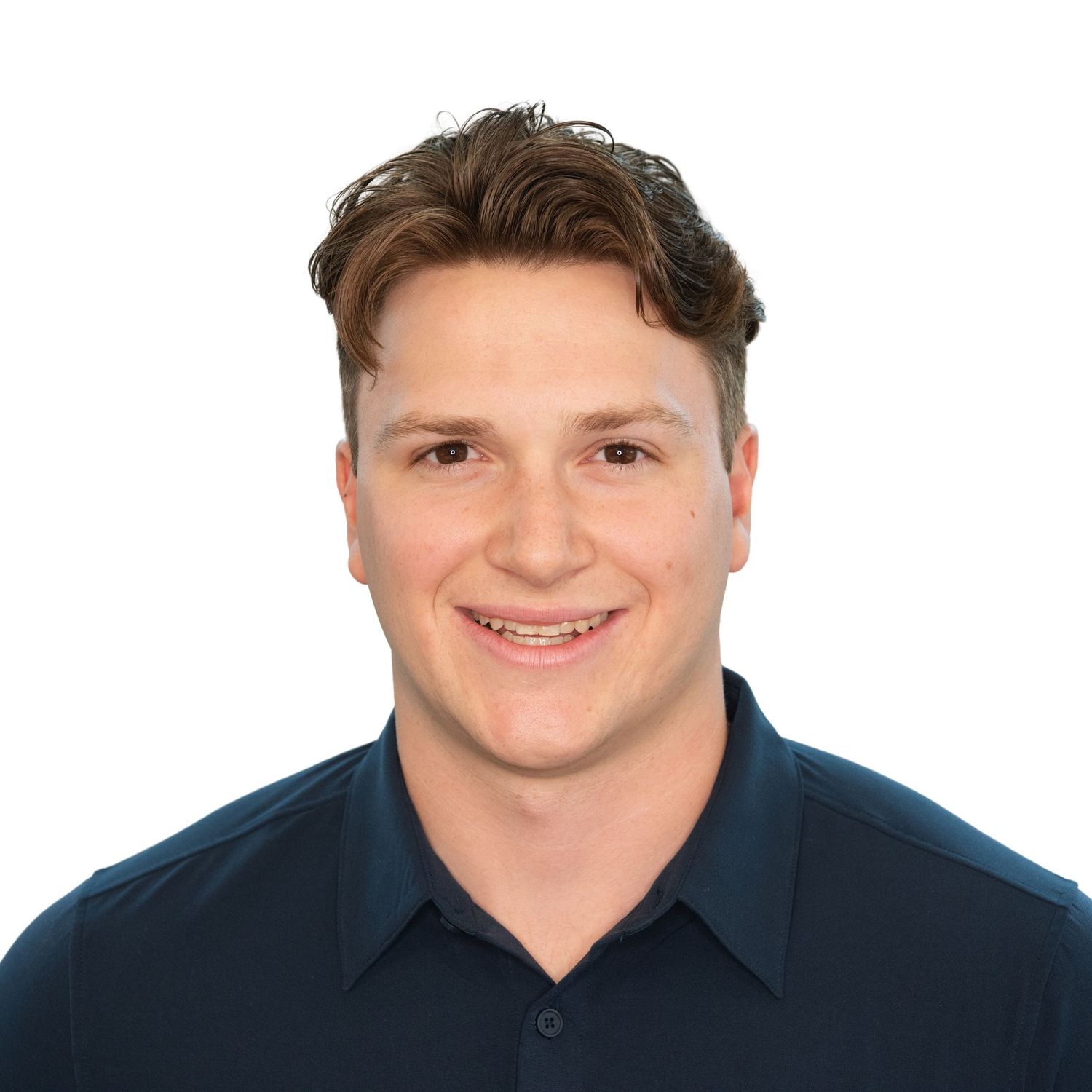 A person in a navy blue collared shirt smiling at the camera in a headshot photo with Leah Ramuglia Photography in Boston,  MA.