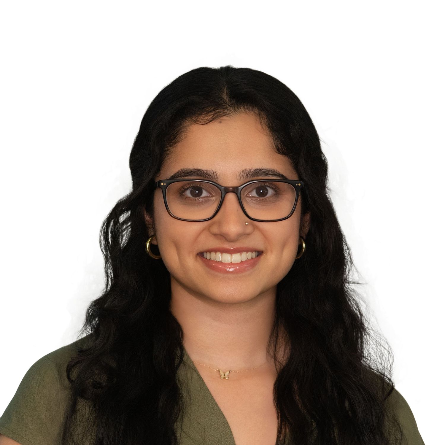 Professional headshot of a person with long dark hair, glasses, and a green top with Leah Ramuglia Photography.