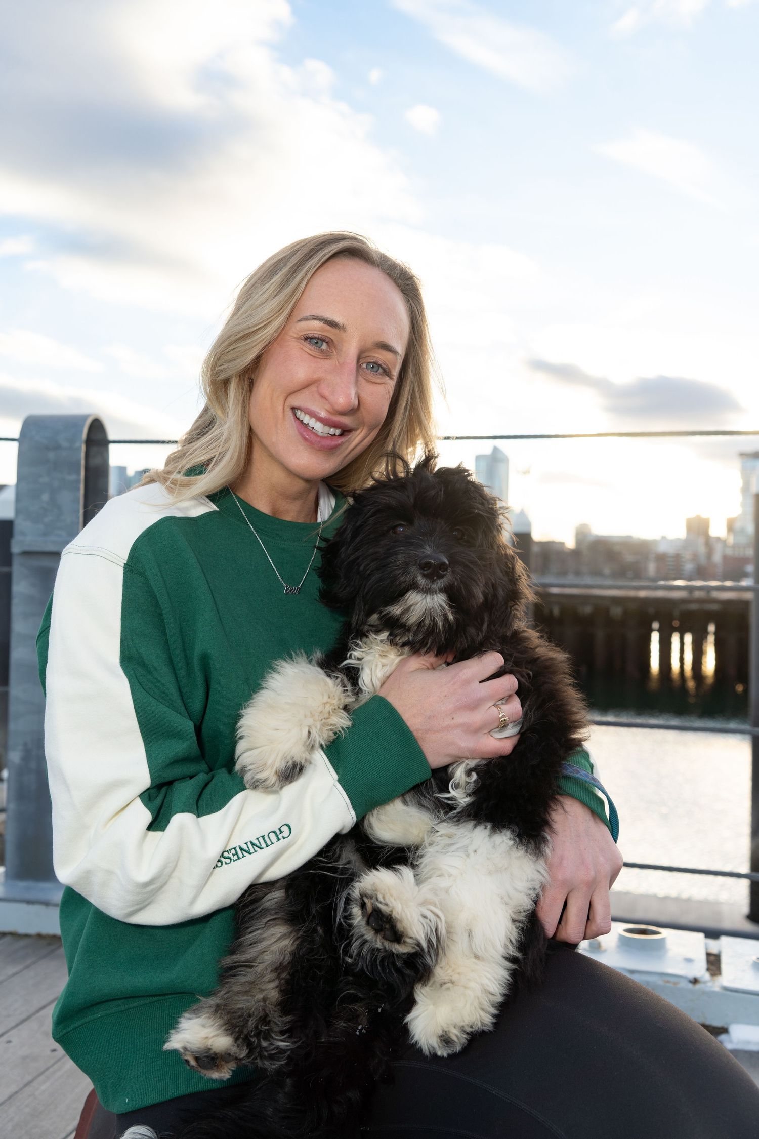 Mom & fur baby Irish Water Spaniel puppy in Boston photographed by Leah Ramuglia Photography in the Charlestown Navy Yard.