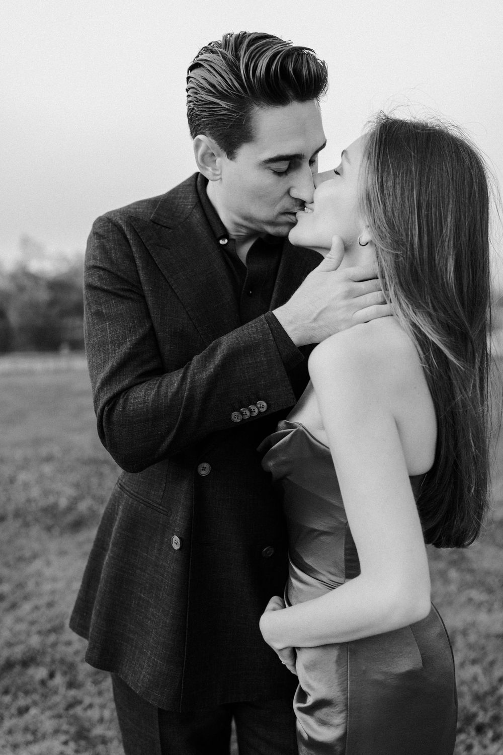 A romantic black and white photo sequence showing a couple embracing and sharing intimate moments in an outdoor setting.