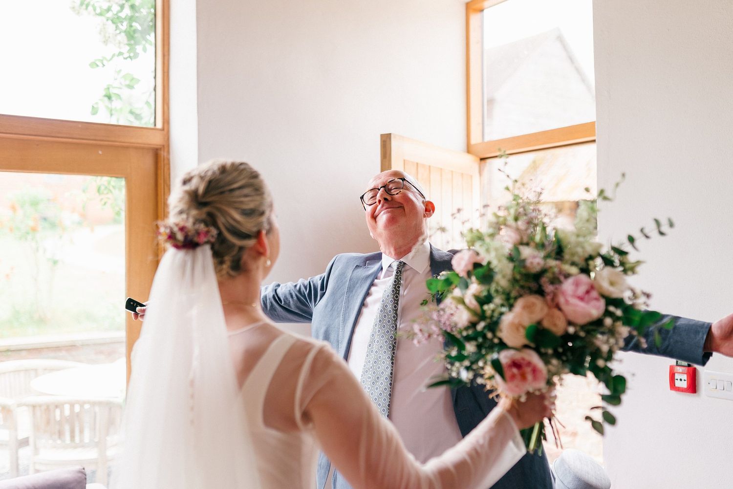 Bride and father sharing an emotional first look moment before the wedding ceremony