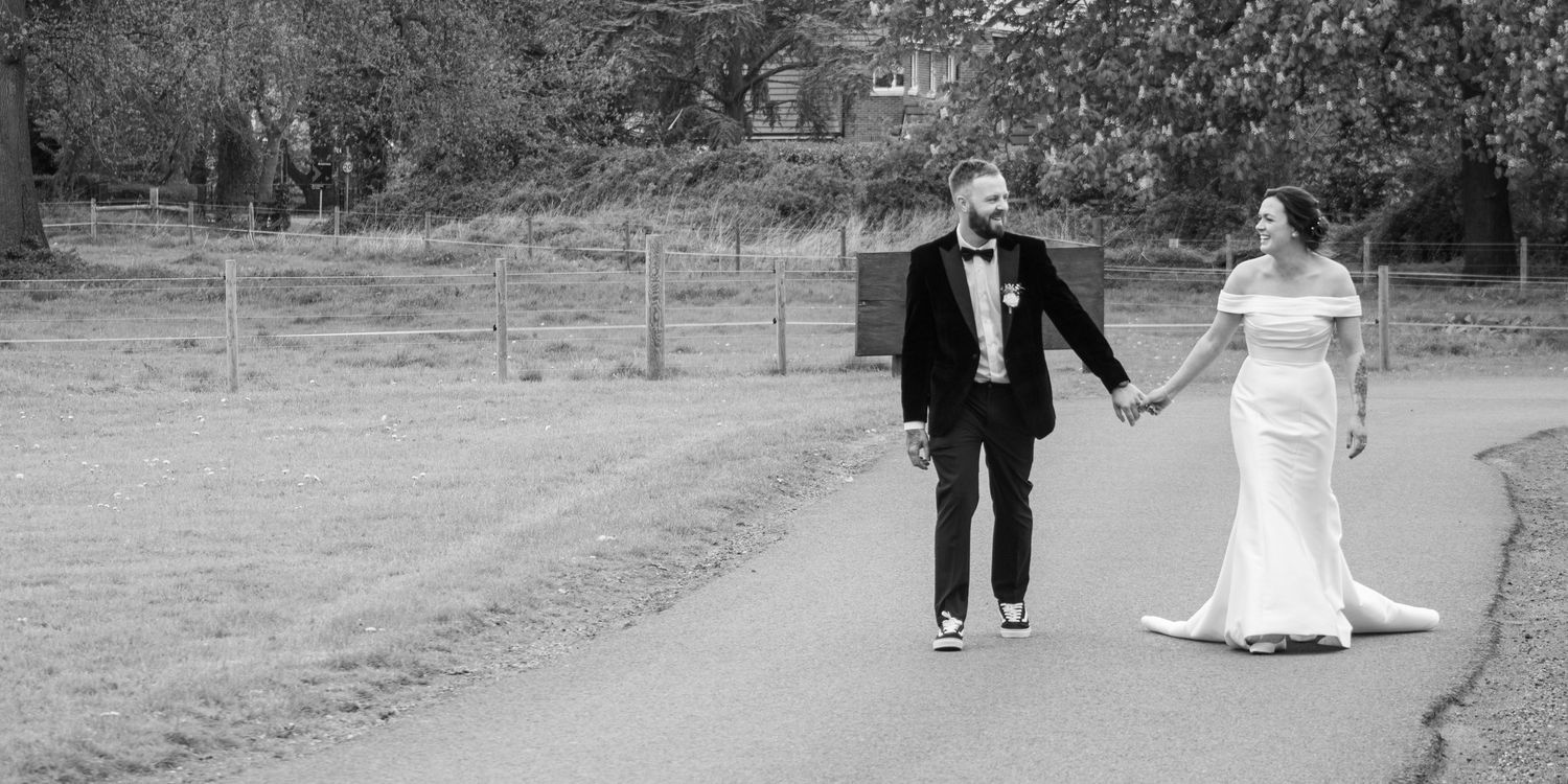 Bride and groom walking through Worcestershire wedding venue grounds