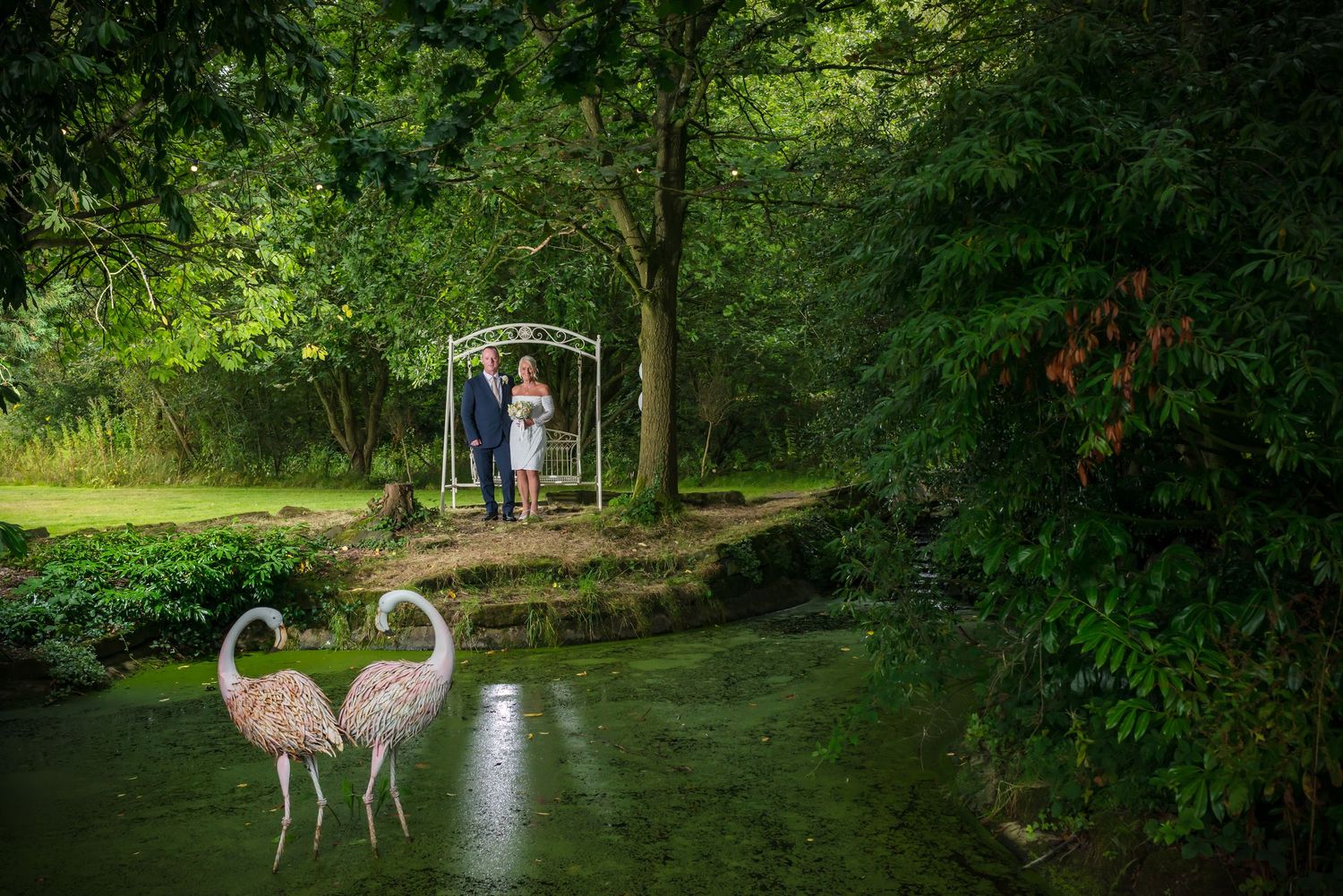 A stunning lakeside wedding portrait at De Vere Cranage Estate in Holmes Chapel; professional wedding photography by Michael Pardoe
