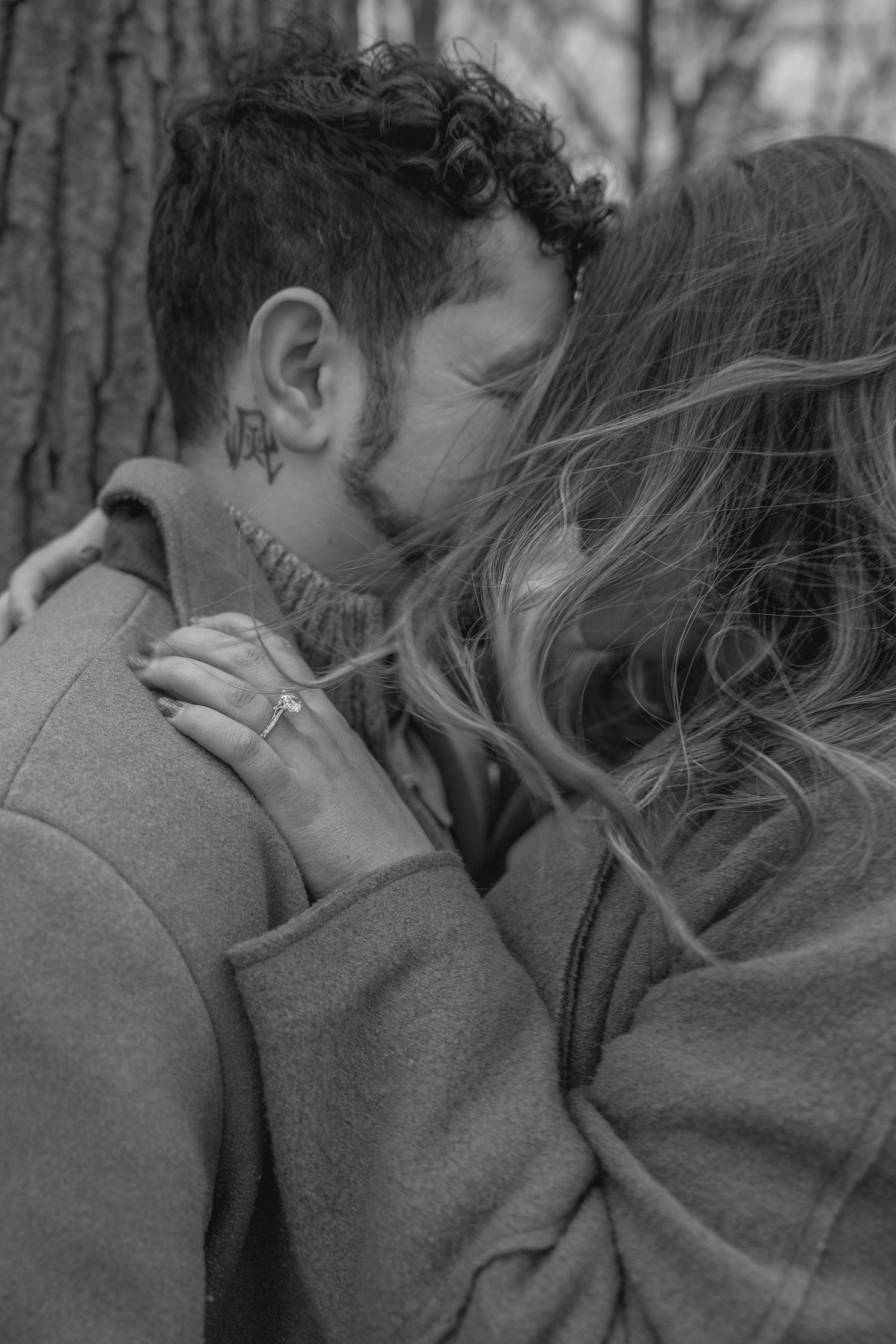 Black and white close-up photo series showing hands with an engagement ring in different poses.