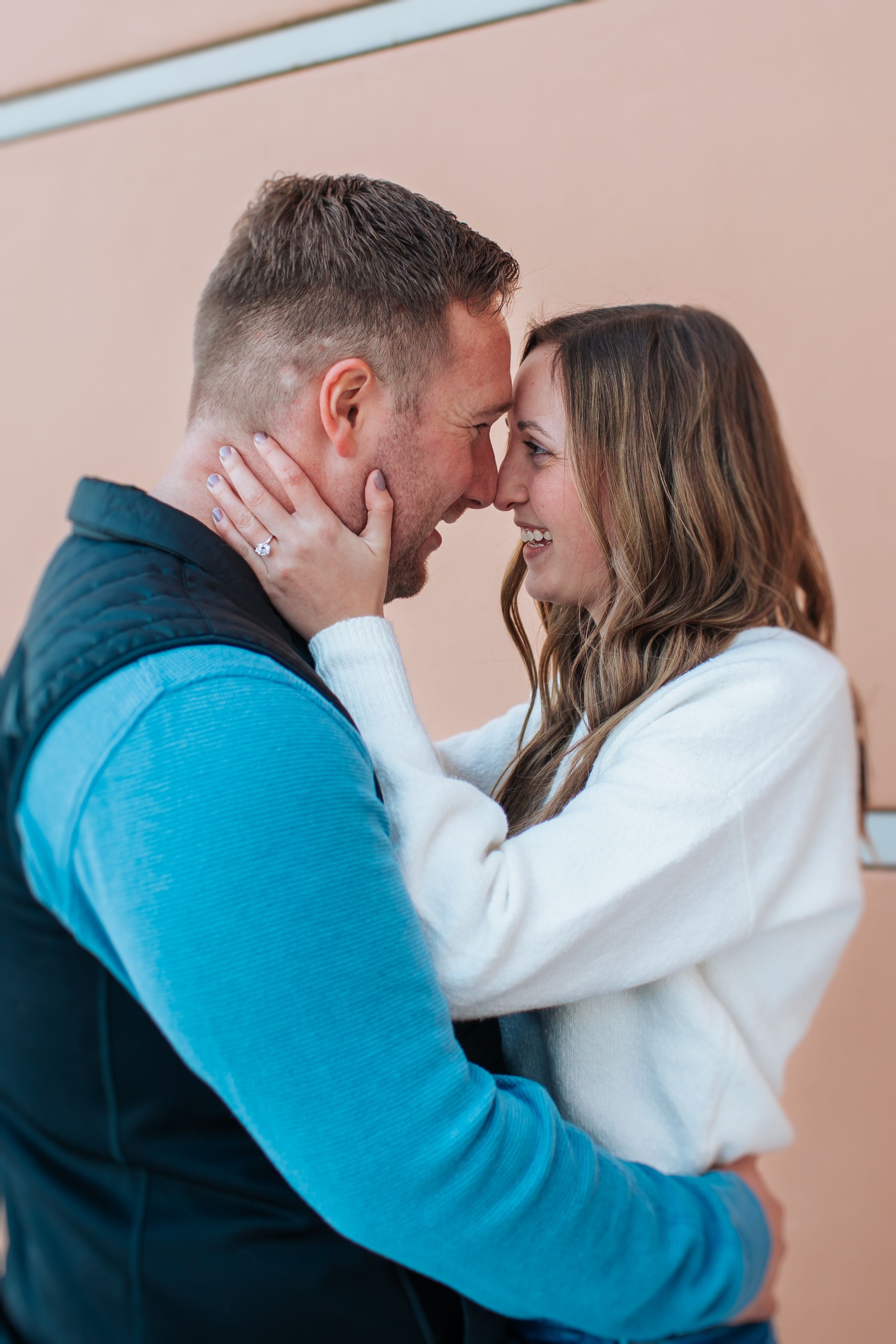 Series of romantic close-up moments against peach-colored wall.