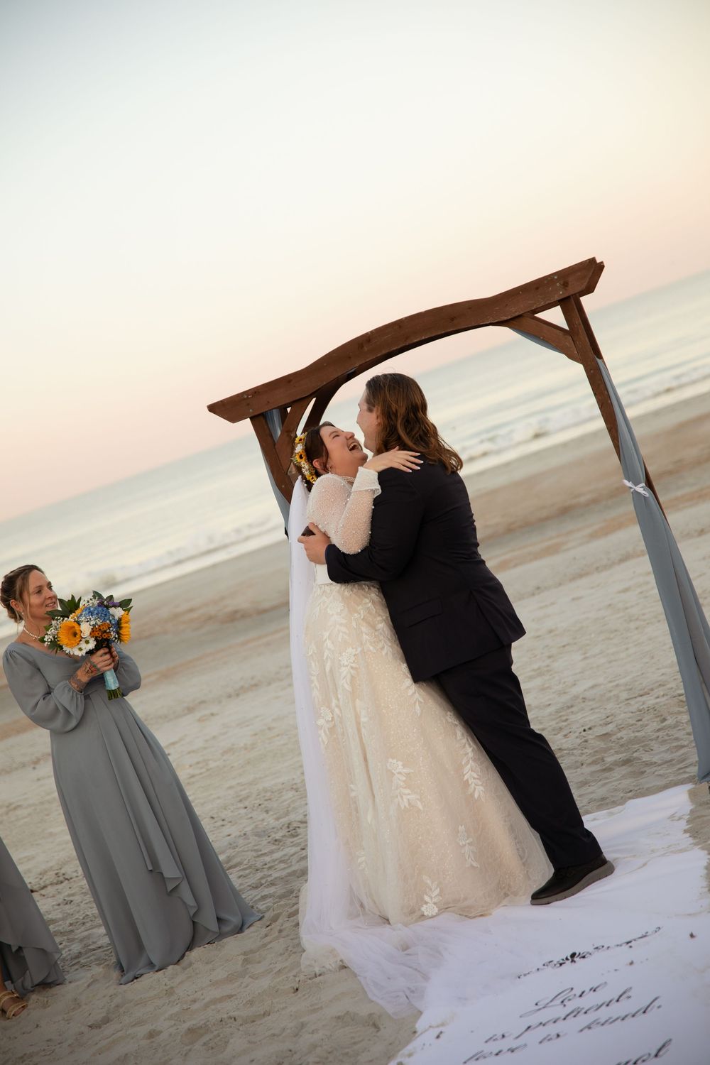 A romantic wedding photo sequence showing a couple dancing together on a beach at sunset.