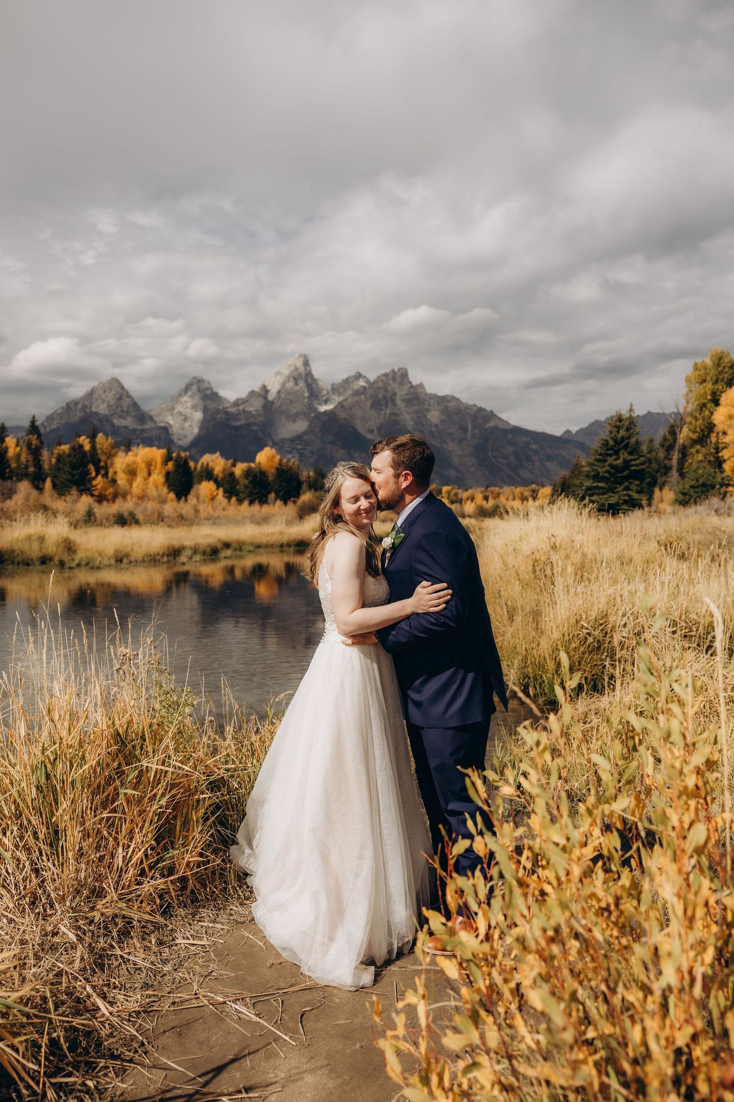 A romantic autumn wedding photoshoot at Grand Teton National Park with dramatic mountain peaks and golden foliage.