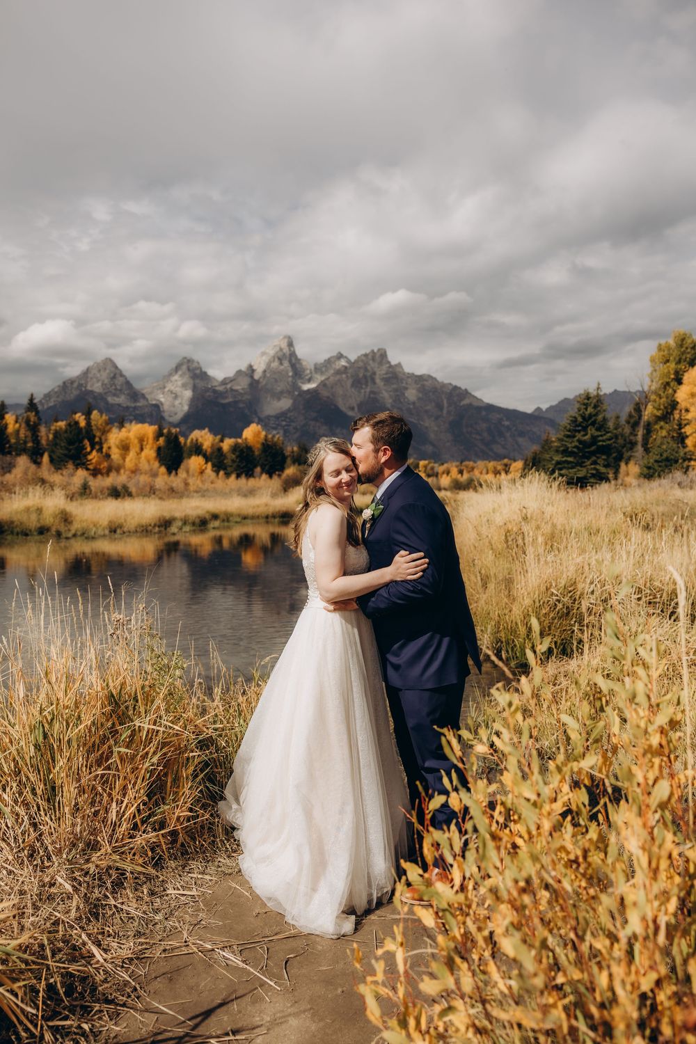 A romantic autumn wedding photoshoot at Grand Teton National Park with dramatic mountain peaks and golden foliage.