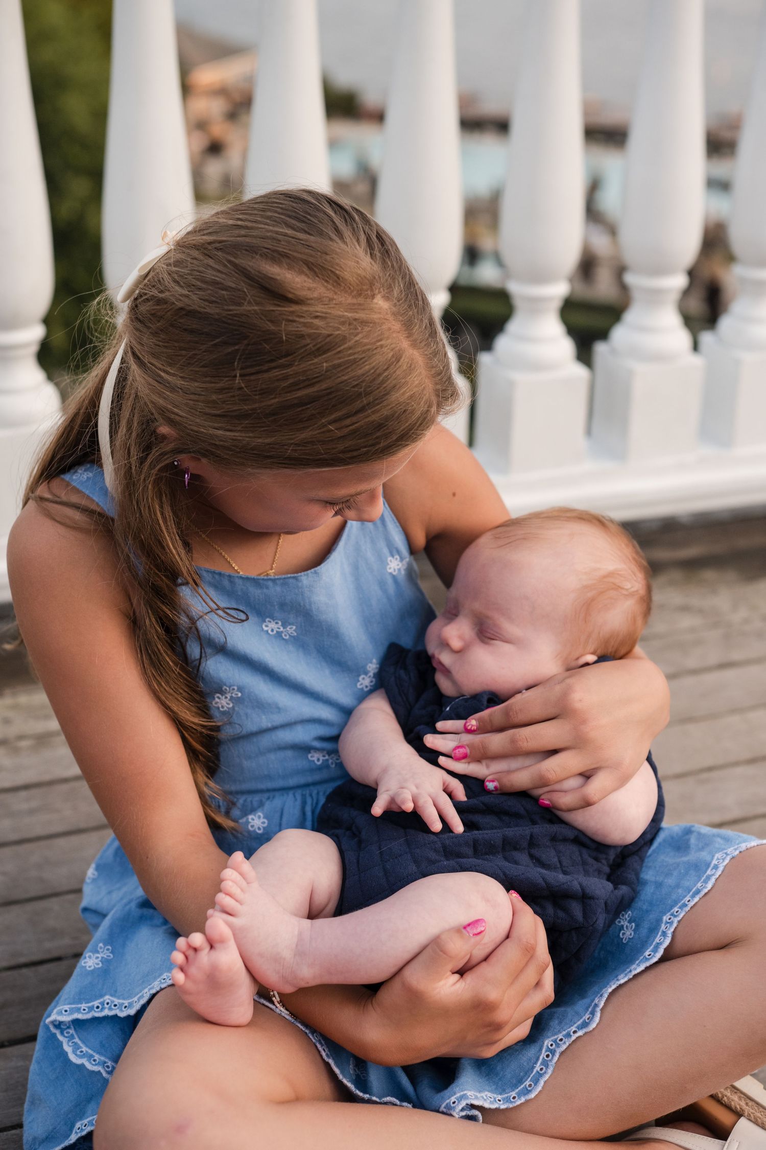 A series of photos showing tender moments between parent and child sitting on a porch with white railings.