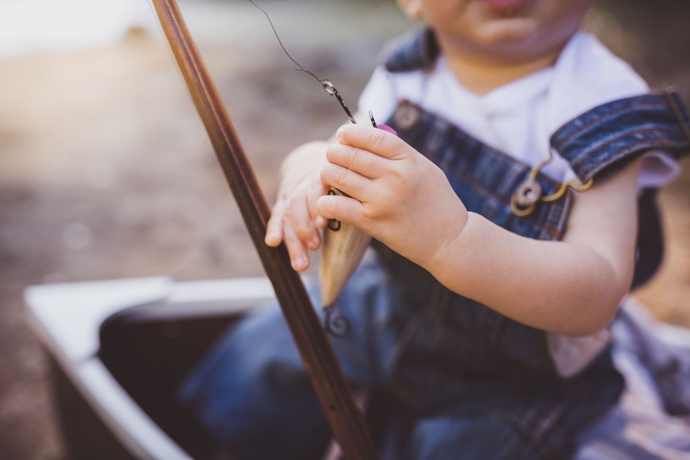 A close-up shot of hands playing violin strings with a bow, demonstrating proper technique and form.