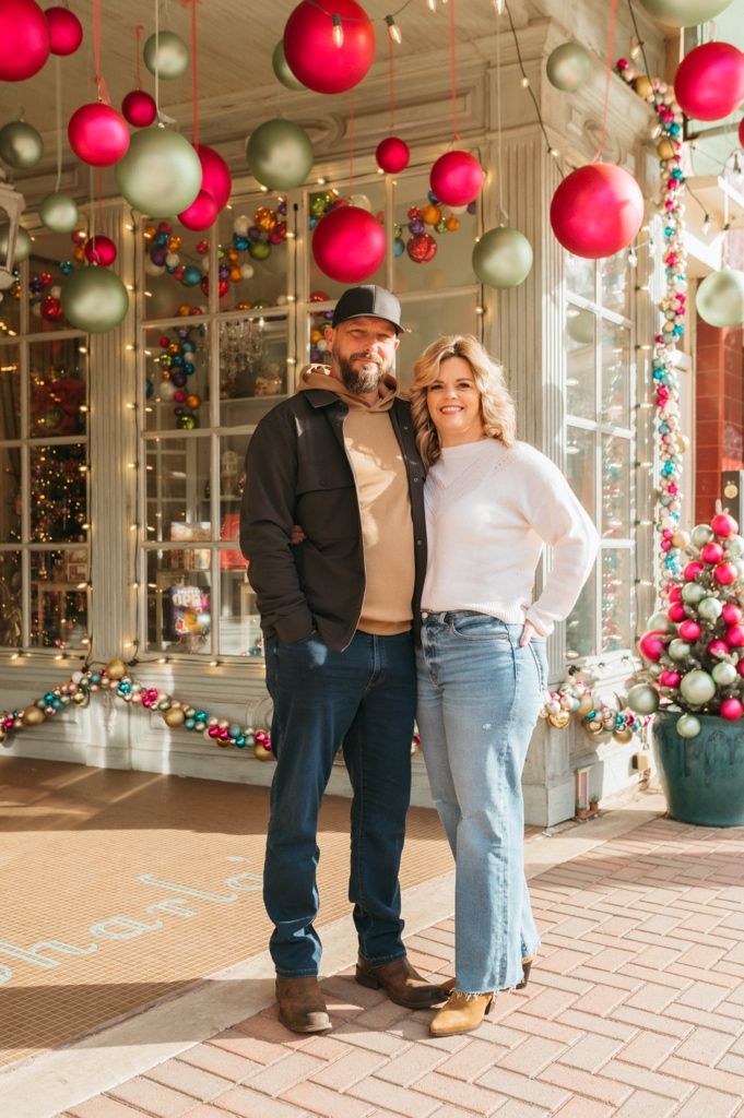 Holiday photos with red and silver balloon decorations in shopping center with festive atmosphere.