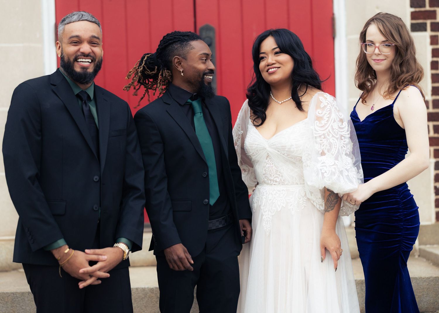 Wedding party group photos in formal attire standing in front of red doors in Baltimore MD