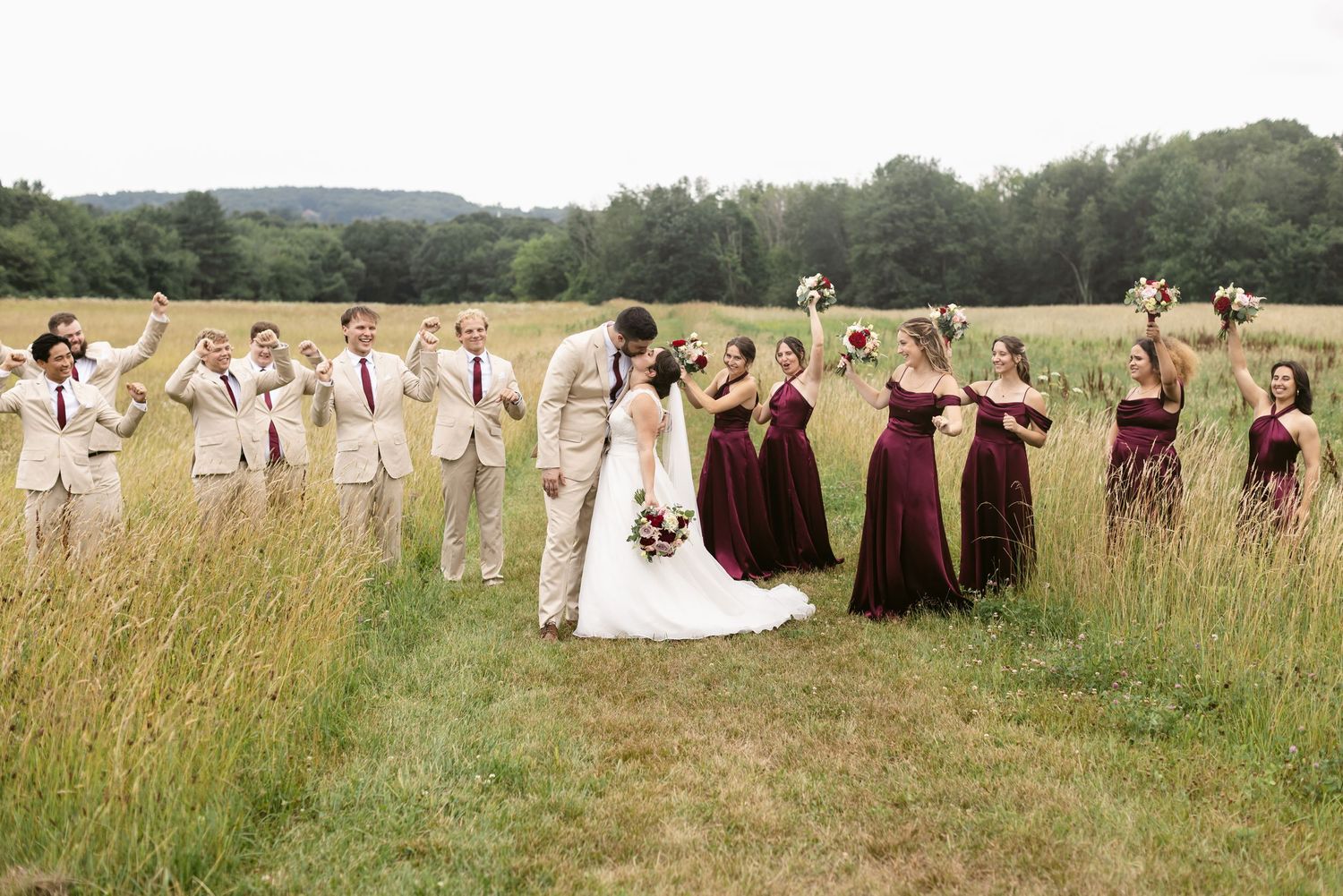 Southern Maine, Seacoast, Lakes Region New Hampshire, North Shore wedding photographer. A wedding party celebrates in a field in Haverhill.