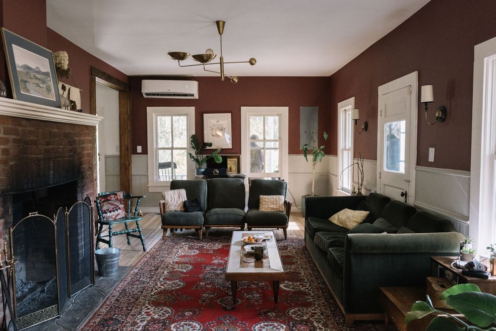 Panoramic view of a cozy living room interior with brown walls and modern furnishings.