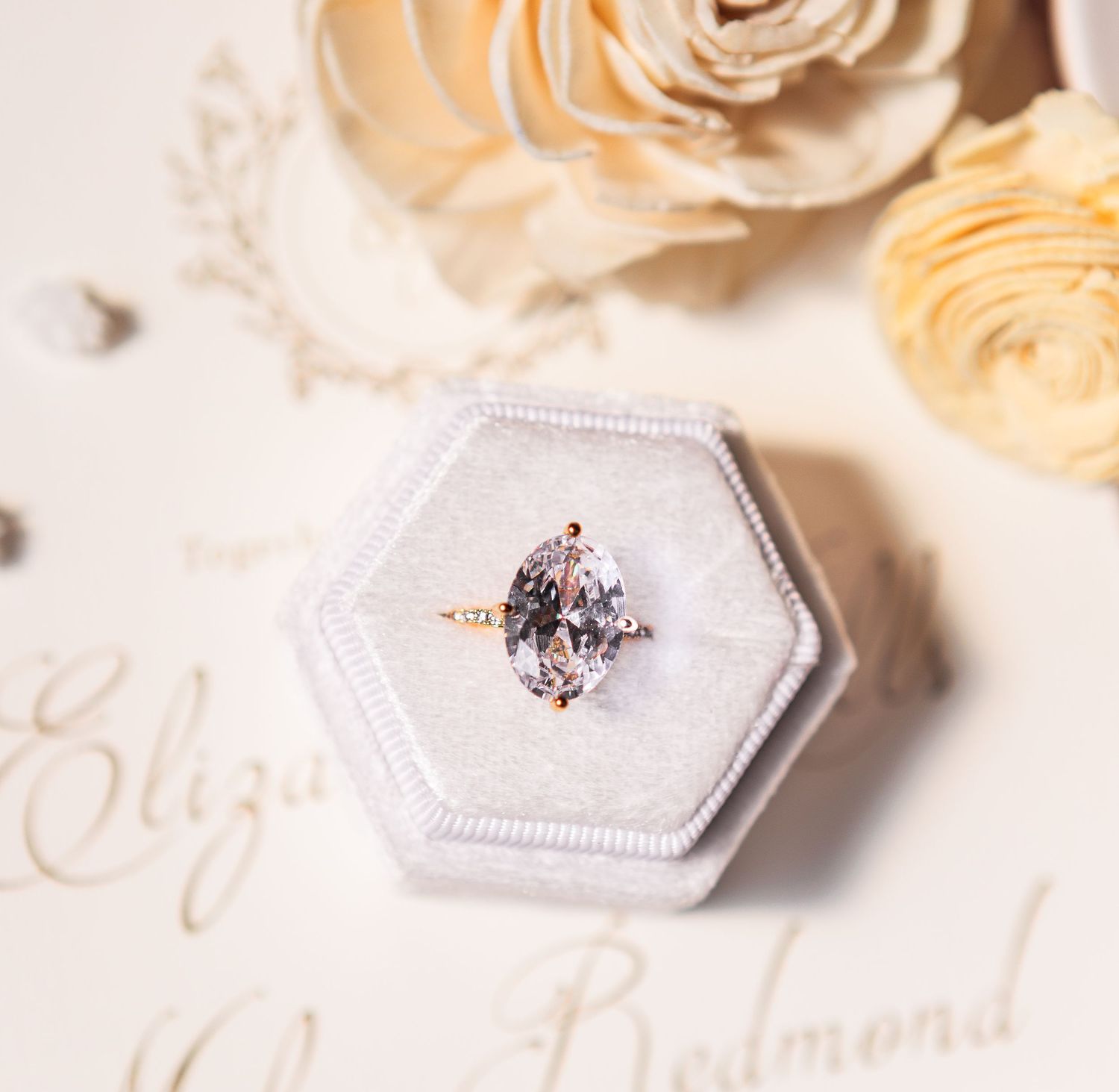 Close-up of an elegant wedding invitation suite and bridal jewelry, showcasing custom designs for a timeless wedding