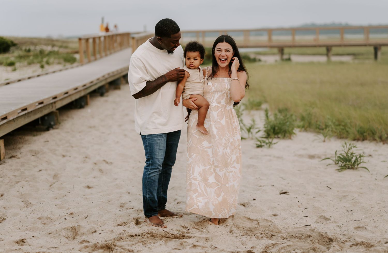 Beach engagement session captured in panoramic style at golden hour.