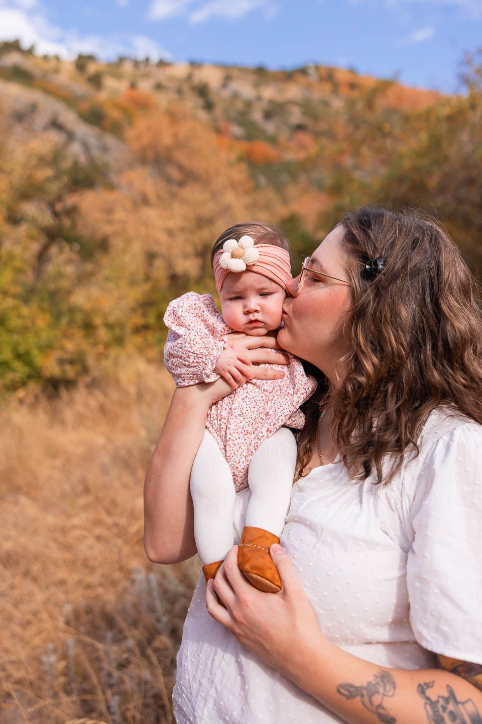 salt lake city utah family photographer, mom kissing newborn in the mountains