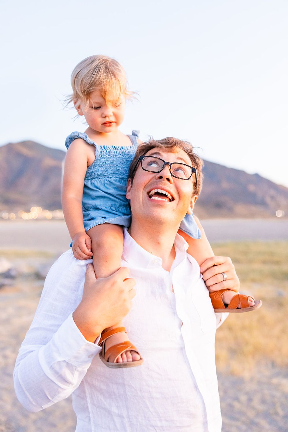 salt lake city utah family photographer, candid photo of a dad with toddler on shoulders