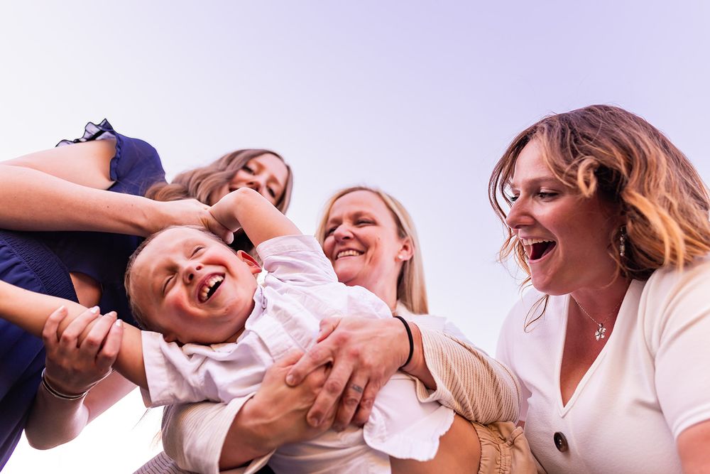salt lake city utah family photographer, candid photo of a family swinging sibling and tickling